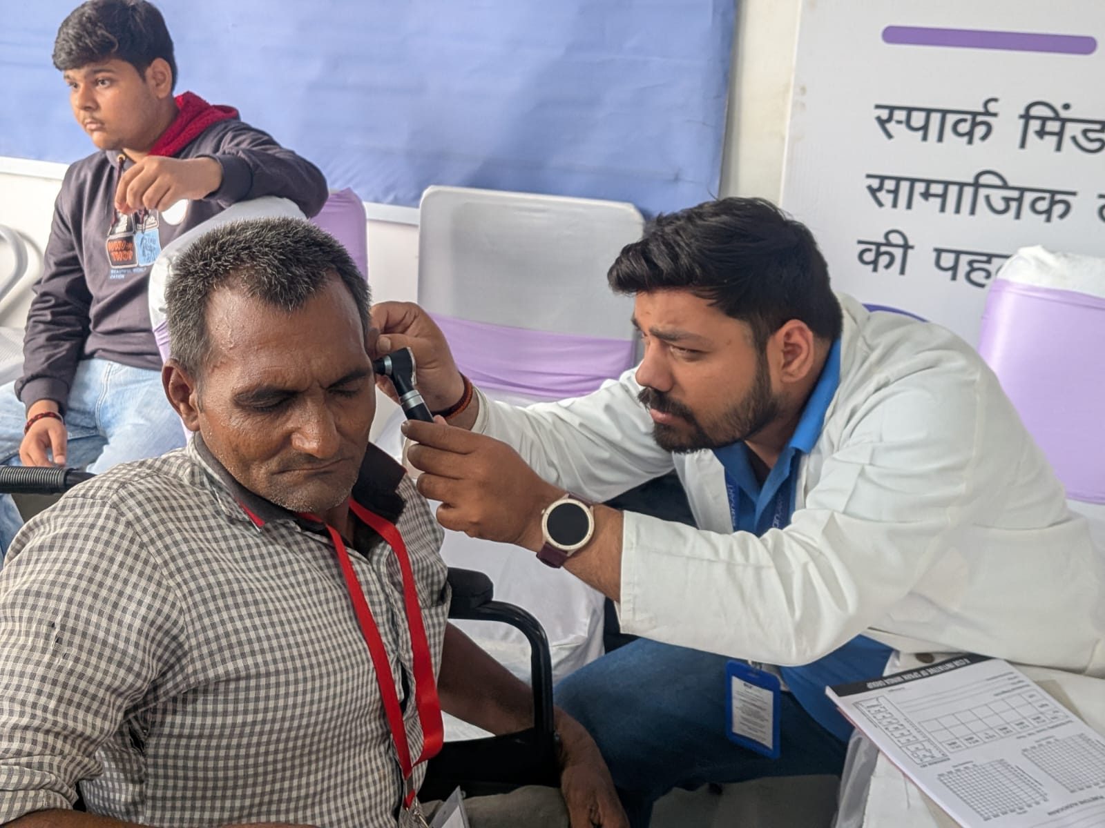 Audiologist performing ear examination